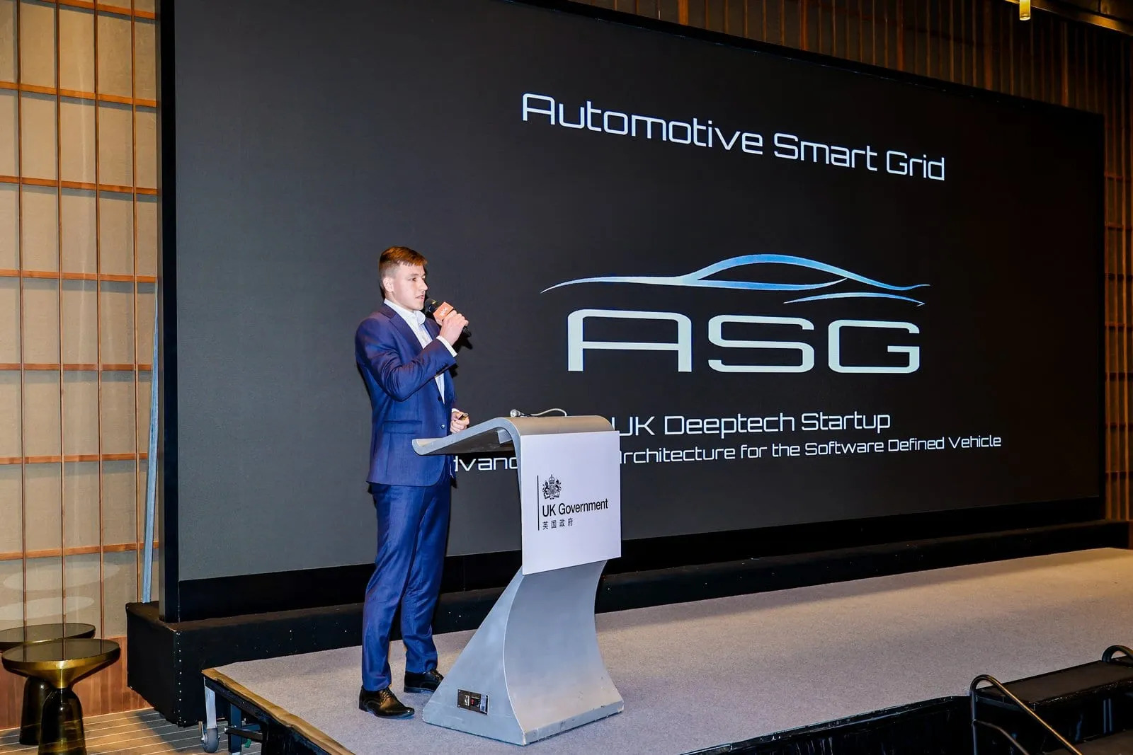 ASG presenting its architecture at the UK-China Automotive Forum in Shanghai, the ASG title slide on the stage screen.