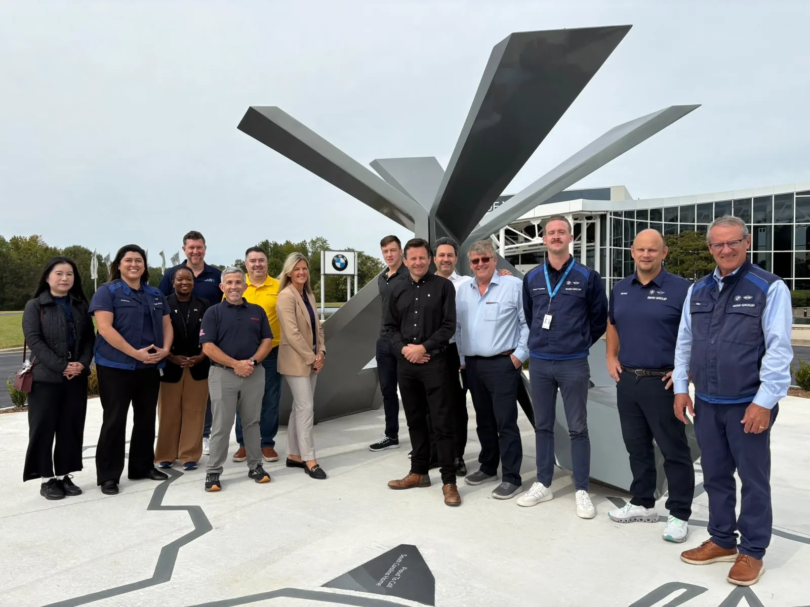 The UK delegation with BMW hosts in front of the X sculpture at BMW’s plant in South Carolina.