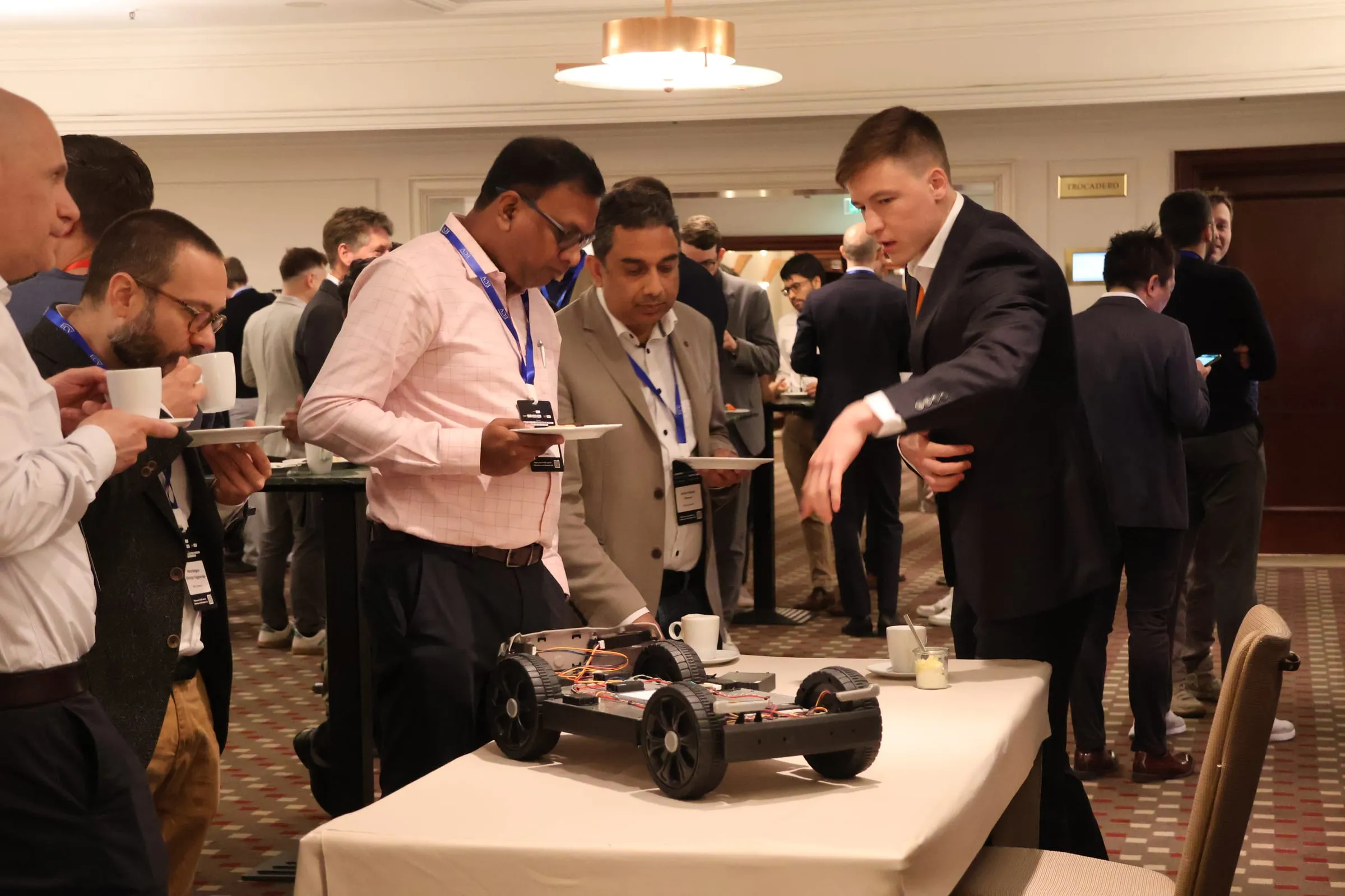 An ASG engineer walking summit attendees through the demo chassis during a break.